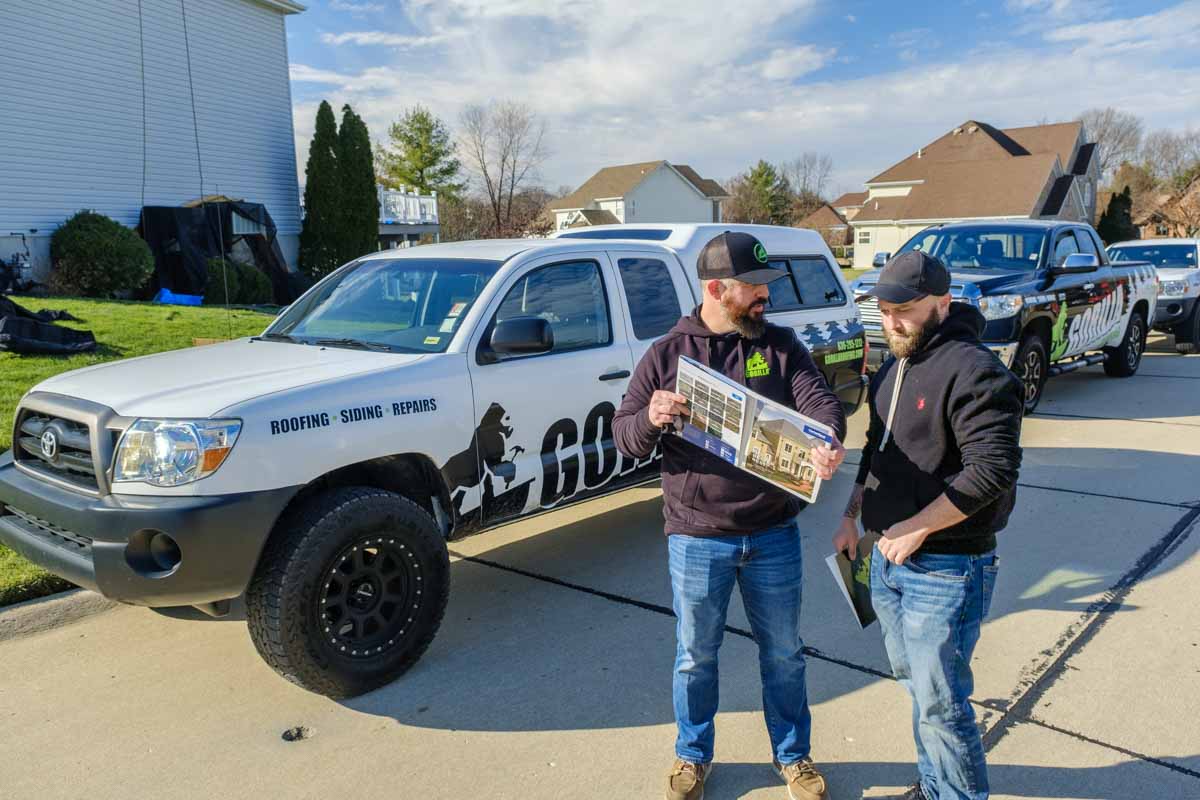 A split image showing a roof renovation process. On the left, a wooden frame with plywood sheets laid out, indicating the 'Before' stage. On the right, a finished roof covered with gray shingles, labeled 'After'.